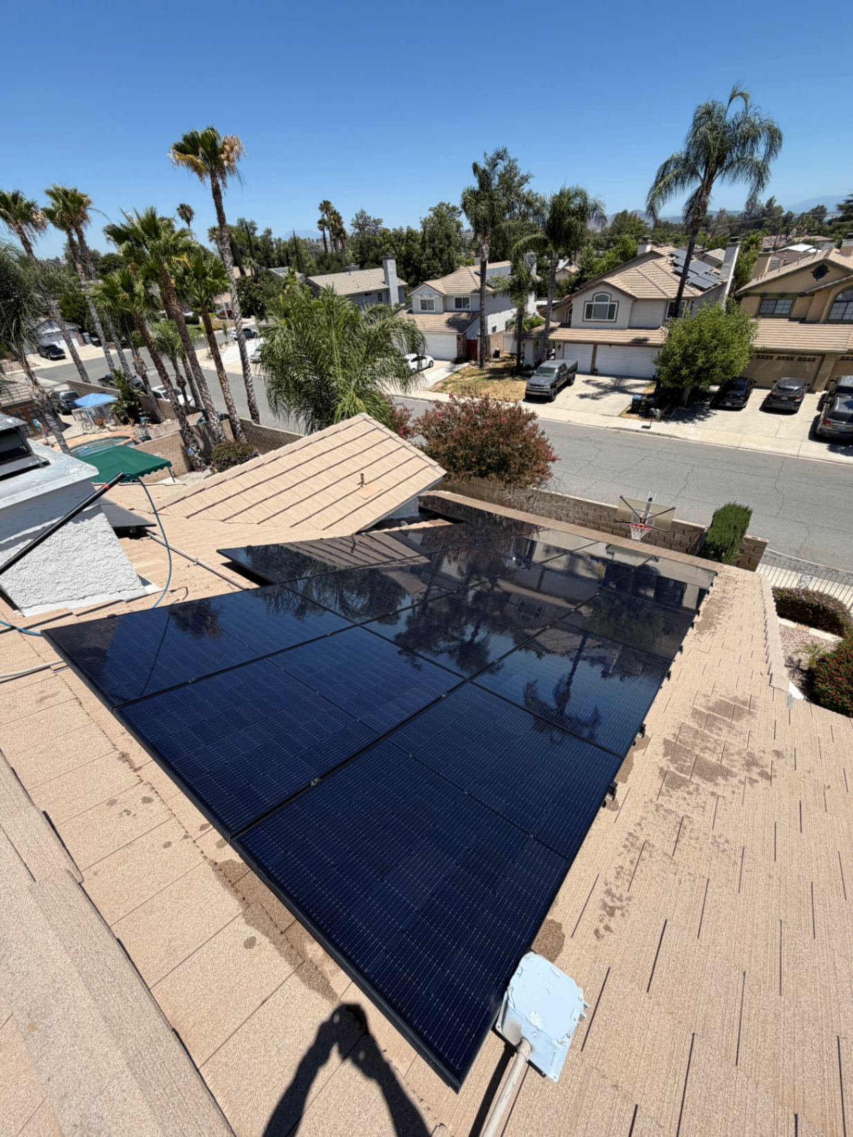 Clean solar array with a suburban neighborhood view